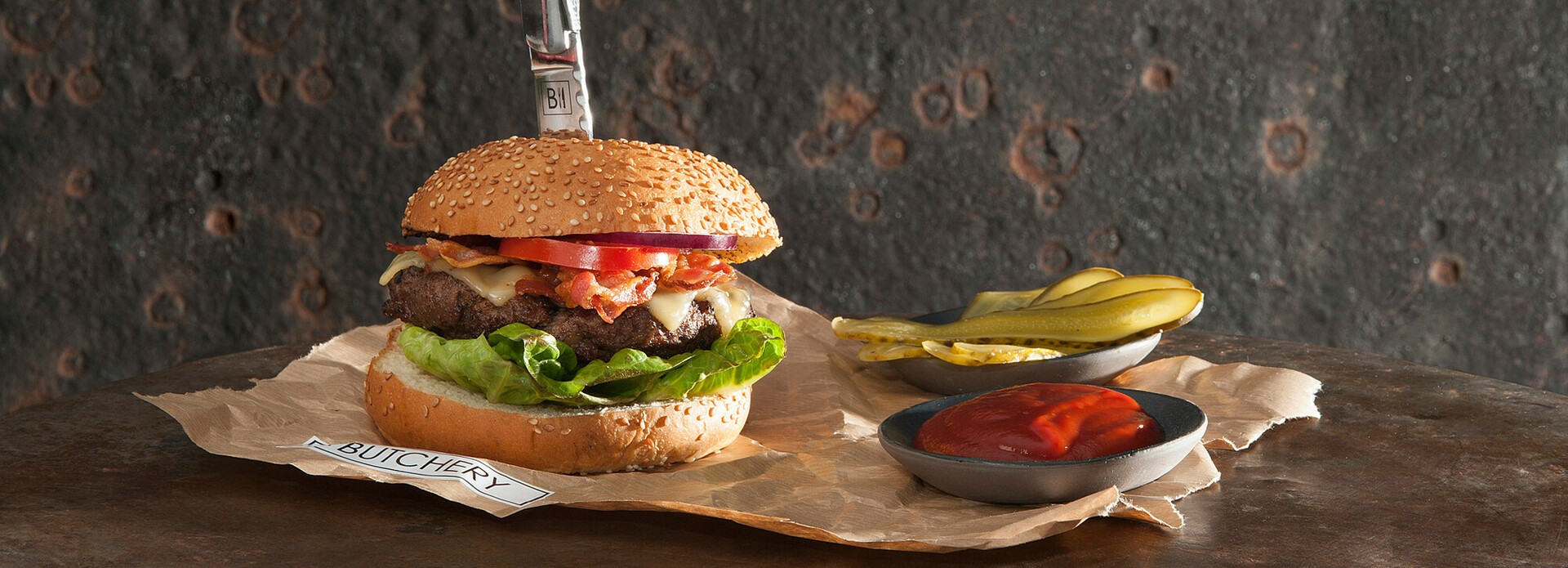 Wagyu burger with cheddar and bacon on a brioche bun