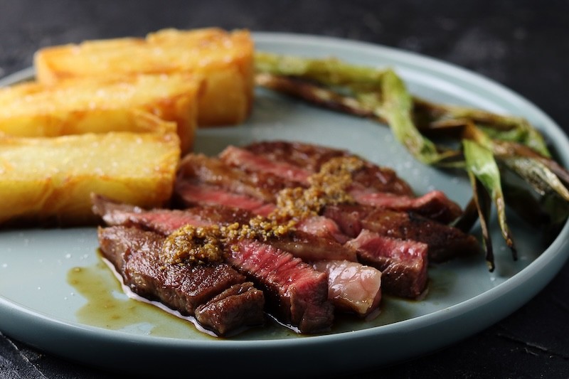 Wagyu ribeye with Japanese steak sauce, 15 hour potato and grilled spring onion
